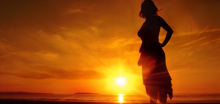 Girl on beach at sunset. Photograph by Lewy Ryan